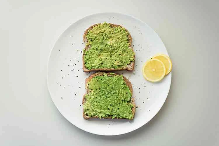 Avocado toast on a white plate