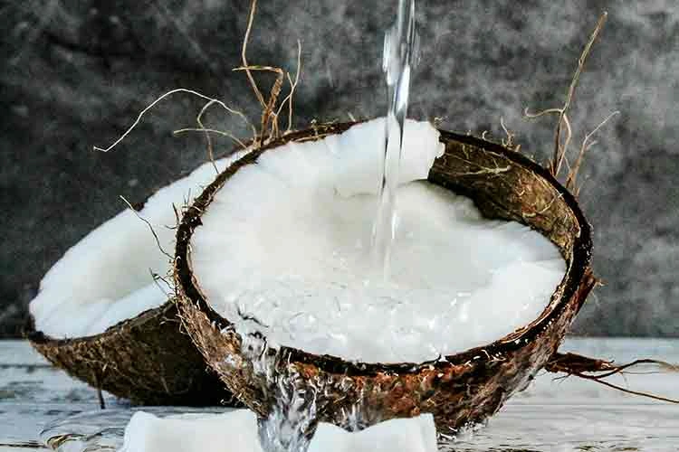 Coconut with water pouring into it.
