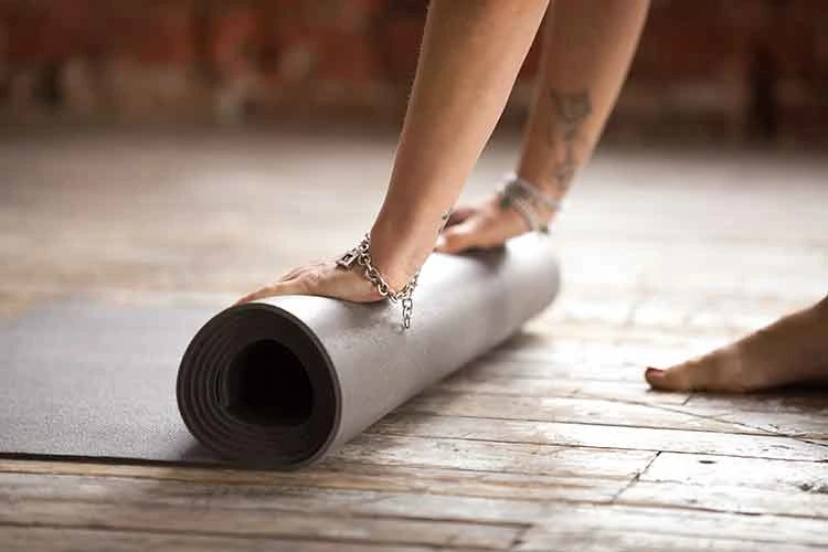 yoga mat being roll out on the floor